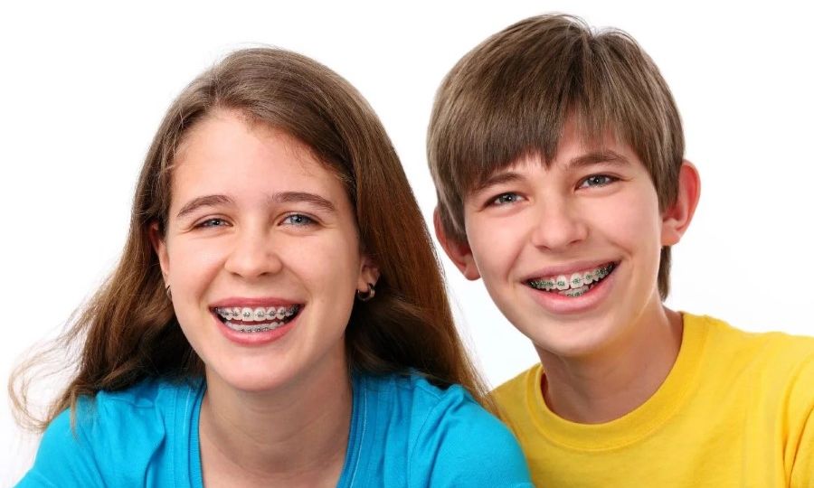 Teen siblings with braces smiling