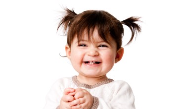 Happy smiling toddler showing baby teeth