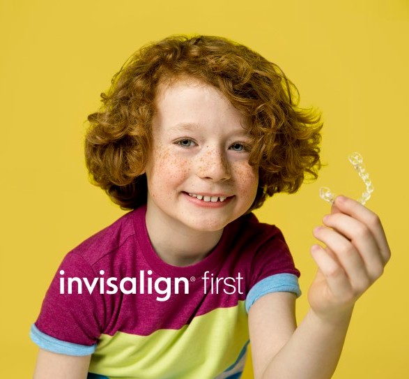 Invisalign First Happy Kid Holding Clear Aligner